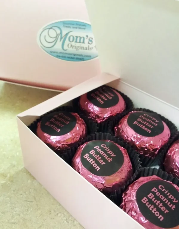 A box of six chocolate covered oreos in pink.