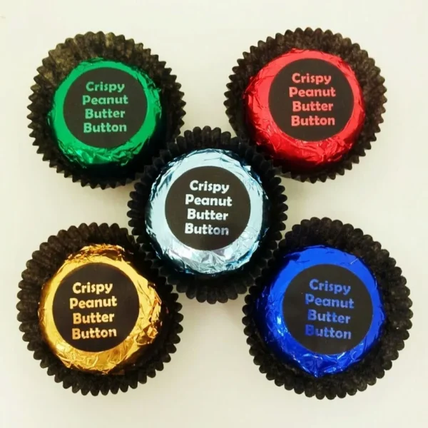 A group of five peanut butter buttons in different colors.