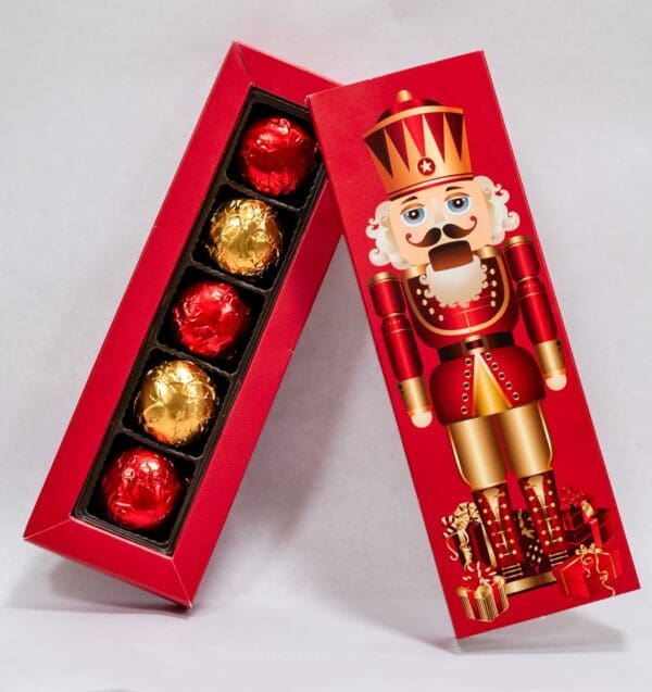 A box of chocolates with a nutcracker on top