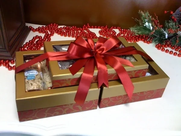 A red bow on top of two boxes.